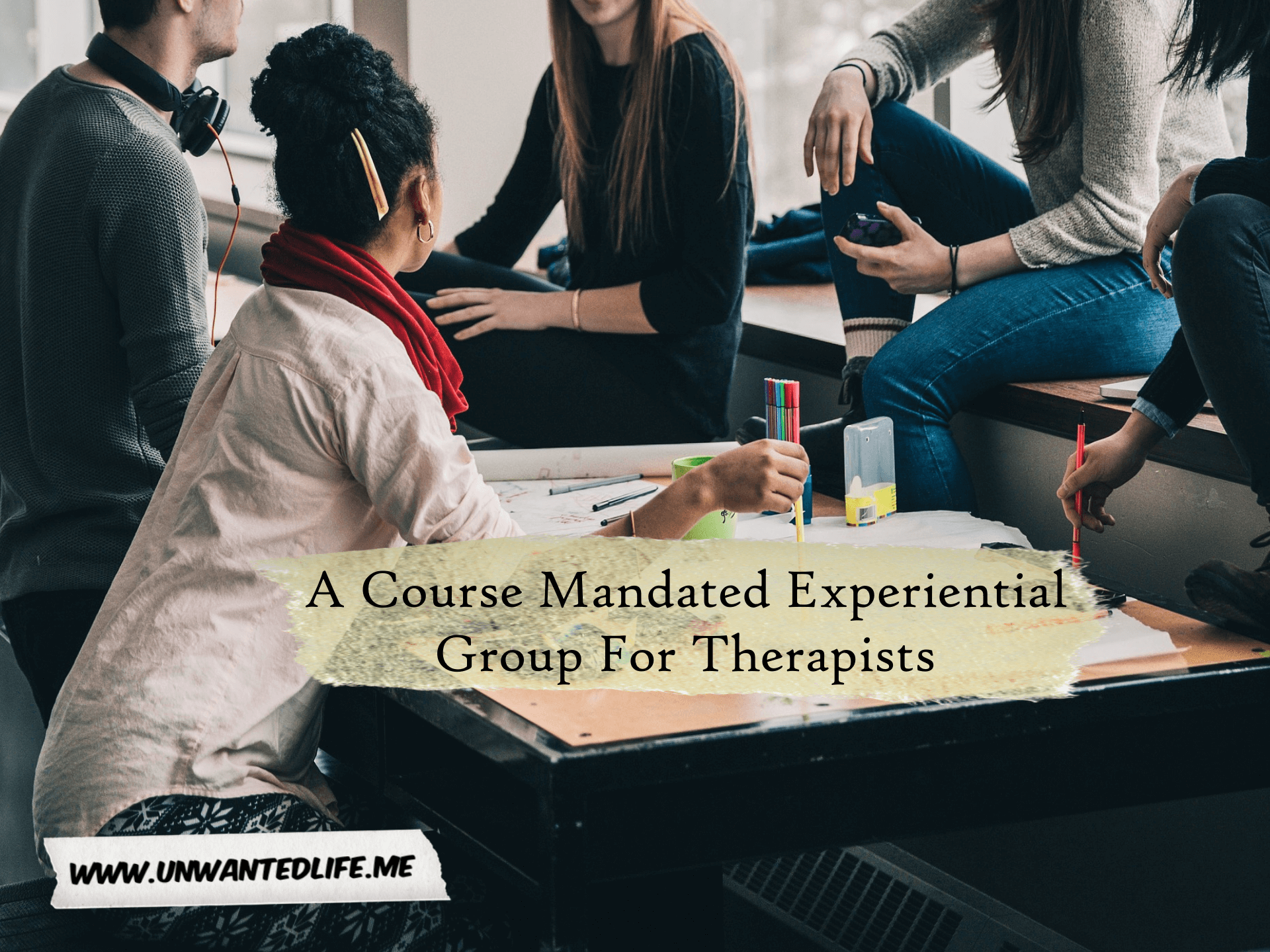 A group of people sitting around a table talking represent the topic of the article - A Course Mandated Experiential Group For Therapists