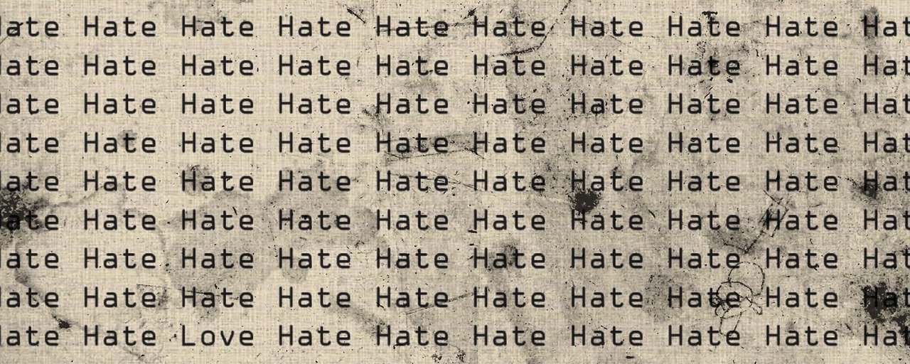 The image just says "hate" repeatedly, but it also says "love" just once amongst the onslaught of to hate word repetition to represent the topic of the article - Brexit And Hate Crimes: Do You Feel Safe?