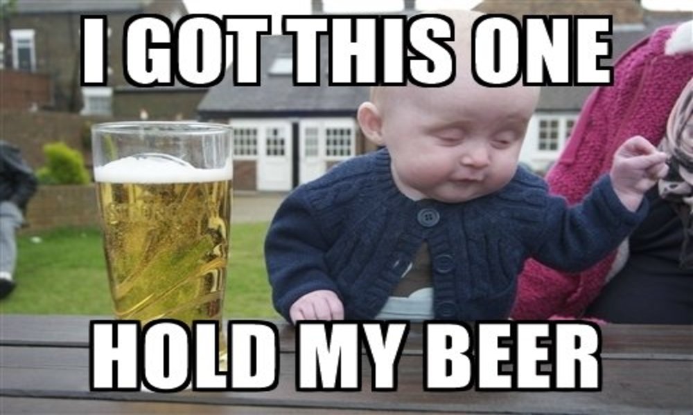 A meme of a baby looking drunk next to a pint of beer to mock Boris Johnson as if he's saying "hold my beer" before being racist