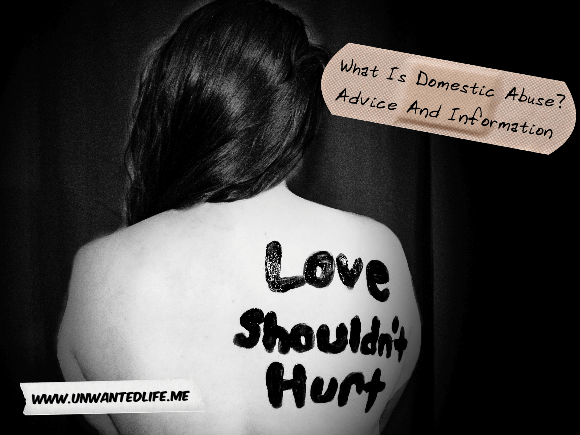 A black and white photo of a woman's back with the words wrote on it that says "love shouldn't hurt" to represent - What Is Domestic Abuse? Advice And Information