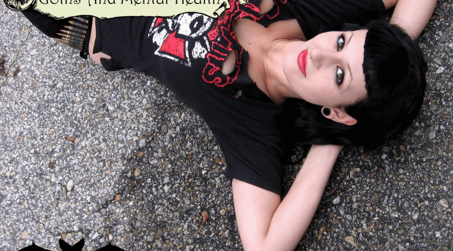 A photo of a female goth laying on a concreate ground outside to represent the topic of the article - Alternative Subcultures: Goths And Mental Health