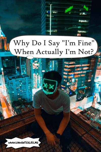A photo of an Asian man with a mask on that have neon lights to hide their face sitting on the edge of a building overlooking a city landscape to represent the topic of the article - Why Do I Say I'm Fine When Actually I'm Not