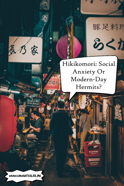 A photo of a lone Asian man in a business suit walking down an ally in Japan with street stalls either side to represent the topic of the article - Hikikomori Social Anxiety Or Modern-Day Hermits
