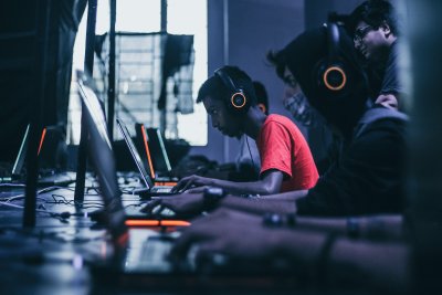 A photo of several males of Indian decent on laptops to represent the topic of the article - Is Gaming Good For Your Mental Health And Wellbeing?