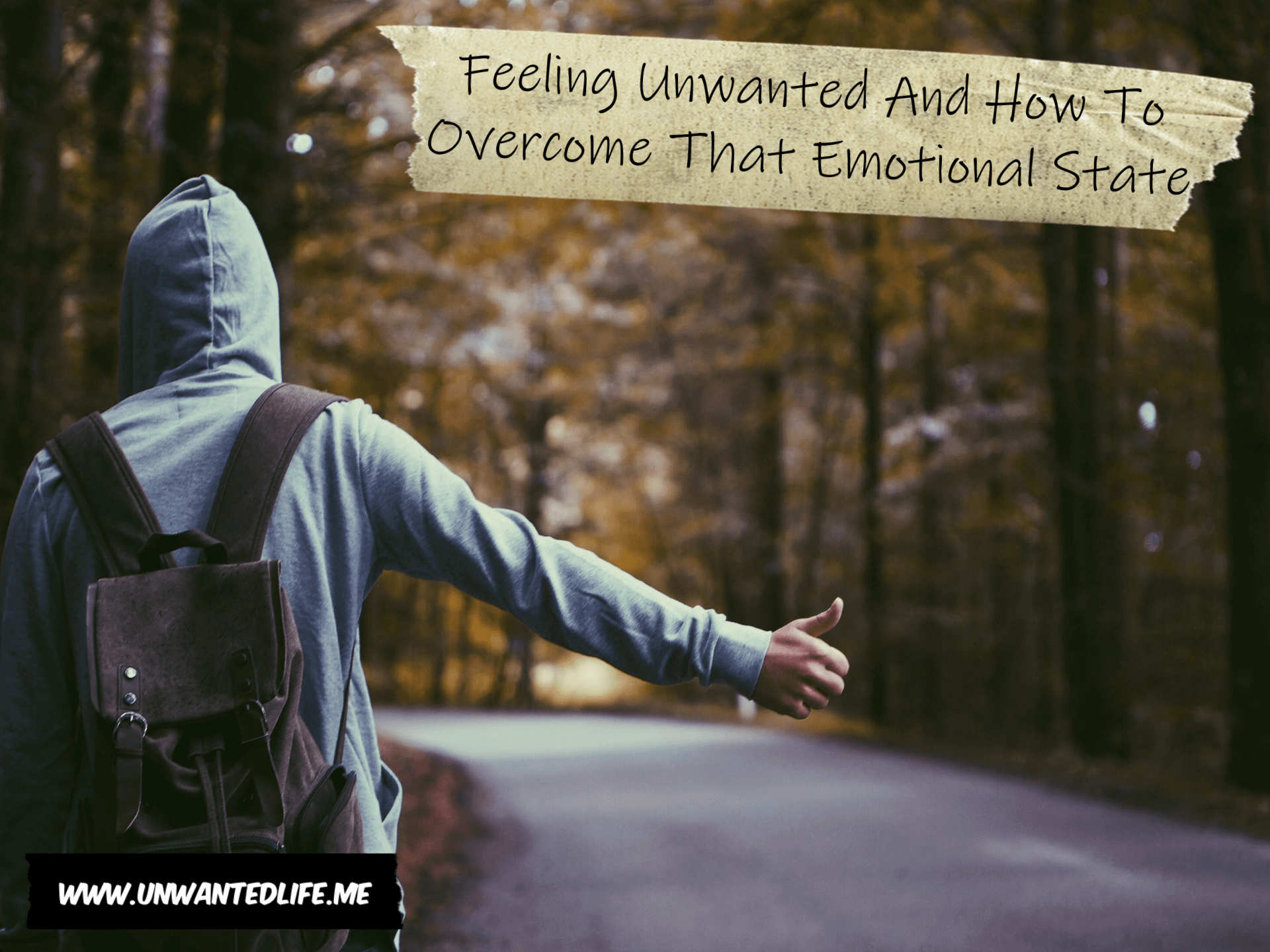 A picture of a person trying to hitchhike on an empty road running through the woods to represent the topic of the article - Feeling Unwanted And How To Overcome That Emotional State
