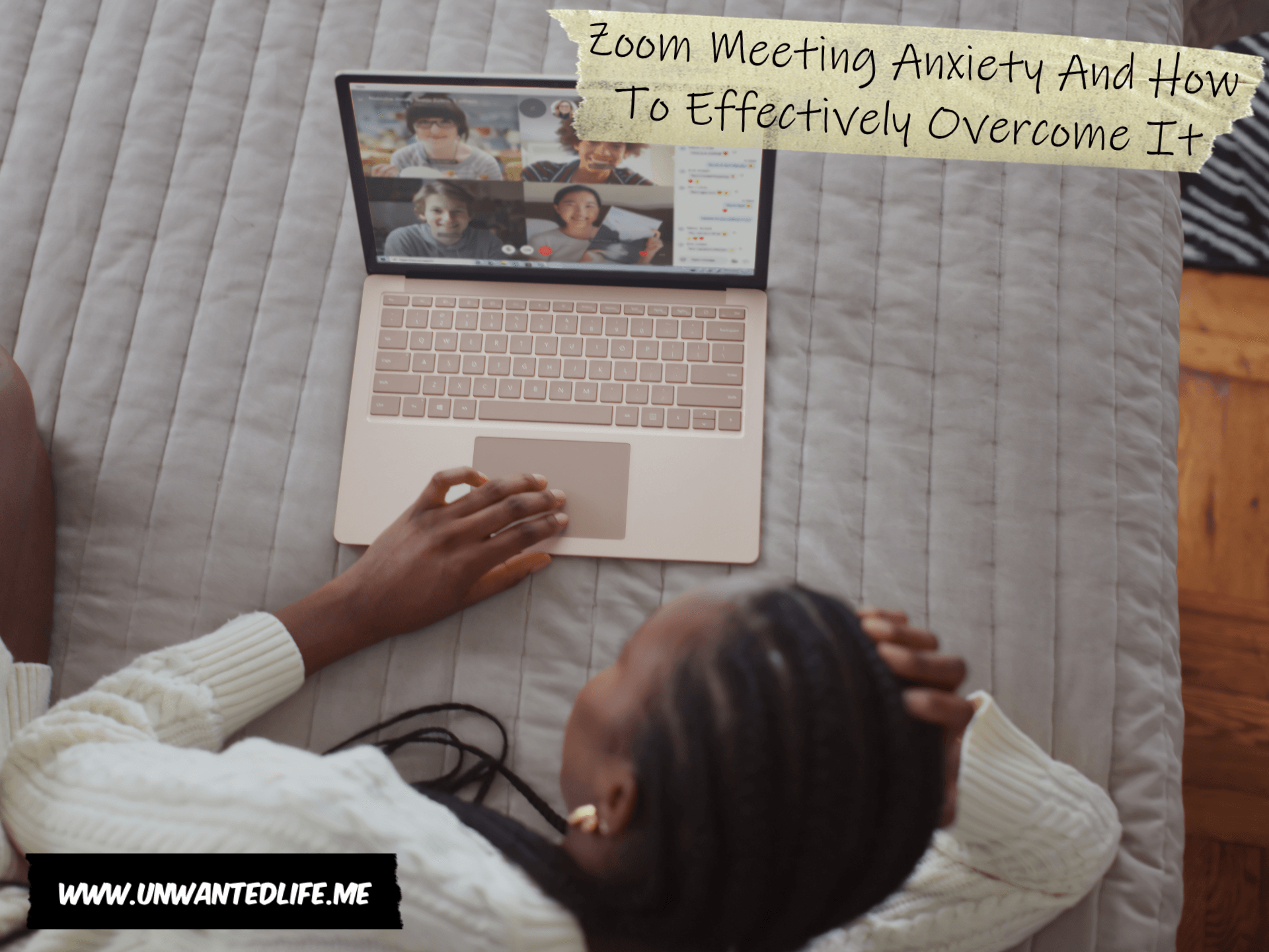 A photo of a young black woman laying across her bed with her laptop open to a group video chat session to represent the topic of the article - Zoom Meeting Anxiety And How To Effectively Overcome It
