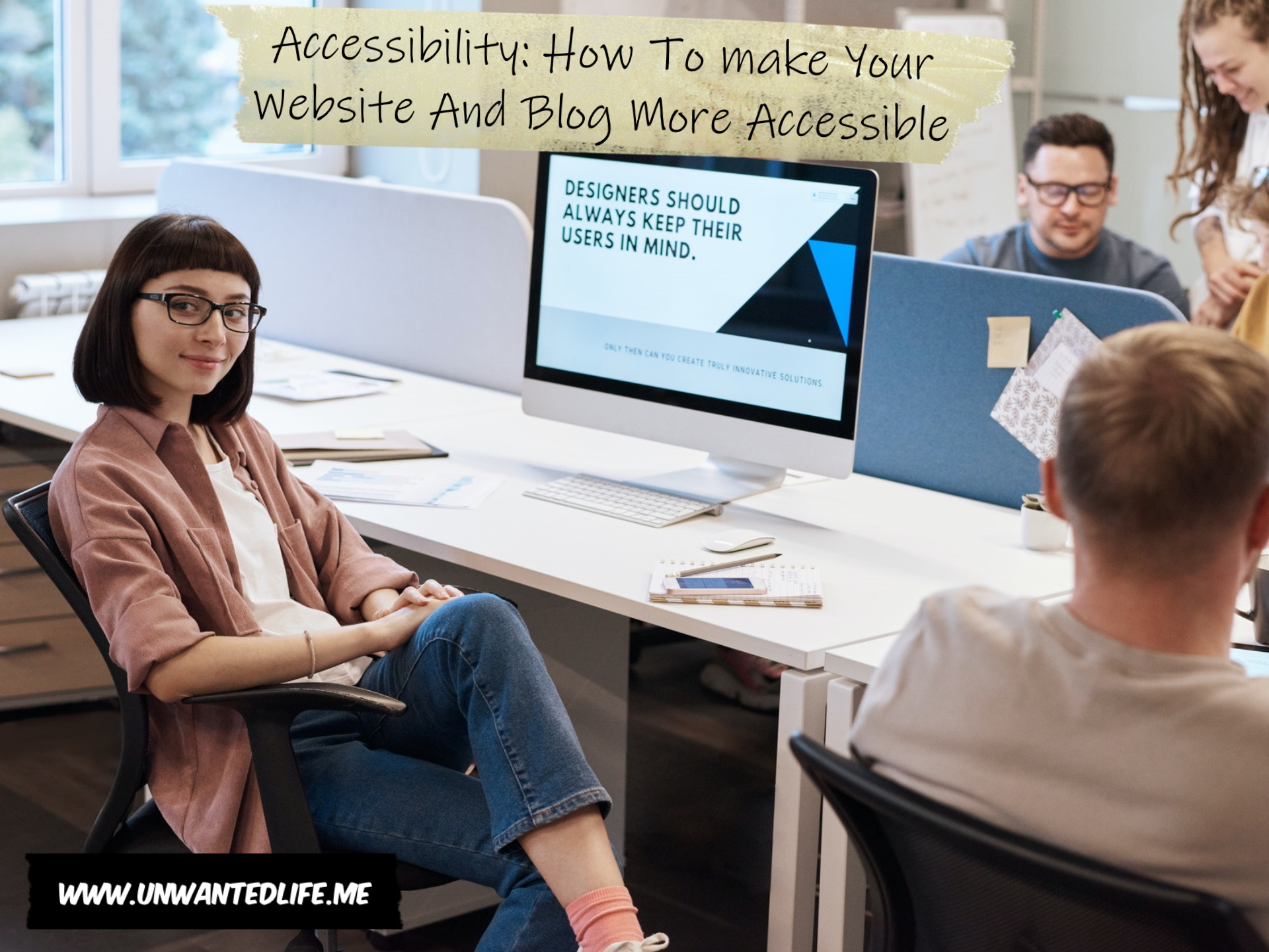 A photo of a white woman in glasses sitting in front of a computer that displays the message "Designers should always keep their users in mind" to represent the topic of the article - Accessibility: How To make Your Website And Blog More Accessible