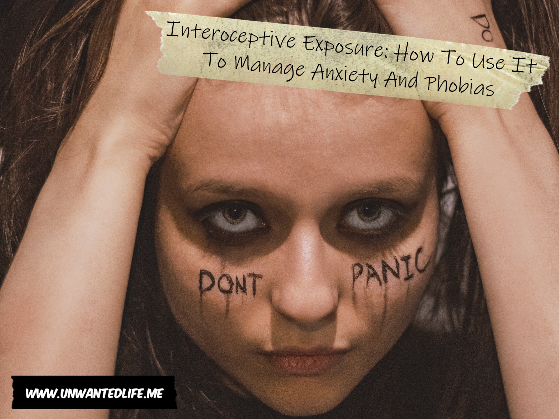 A photo of a white woman with her head in her hand and "don't panic" wrote across her face and "do" on her left hand to represent the topic of the article - Interoceptive Exposure: How To Use It To Manage Anxiety And Phobias