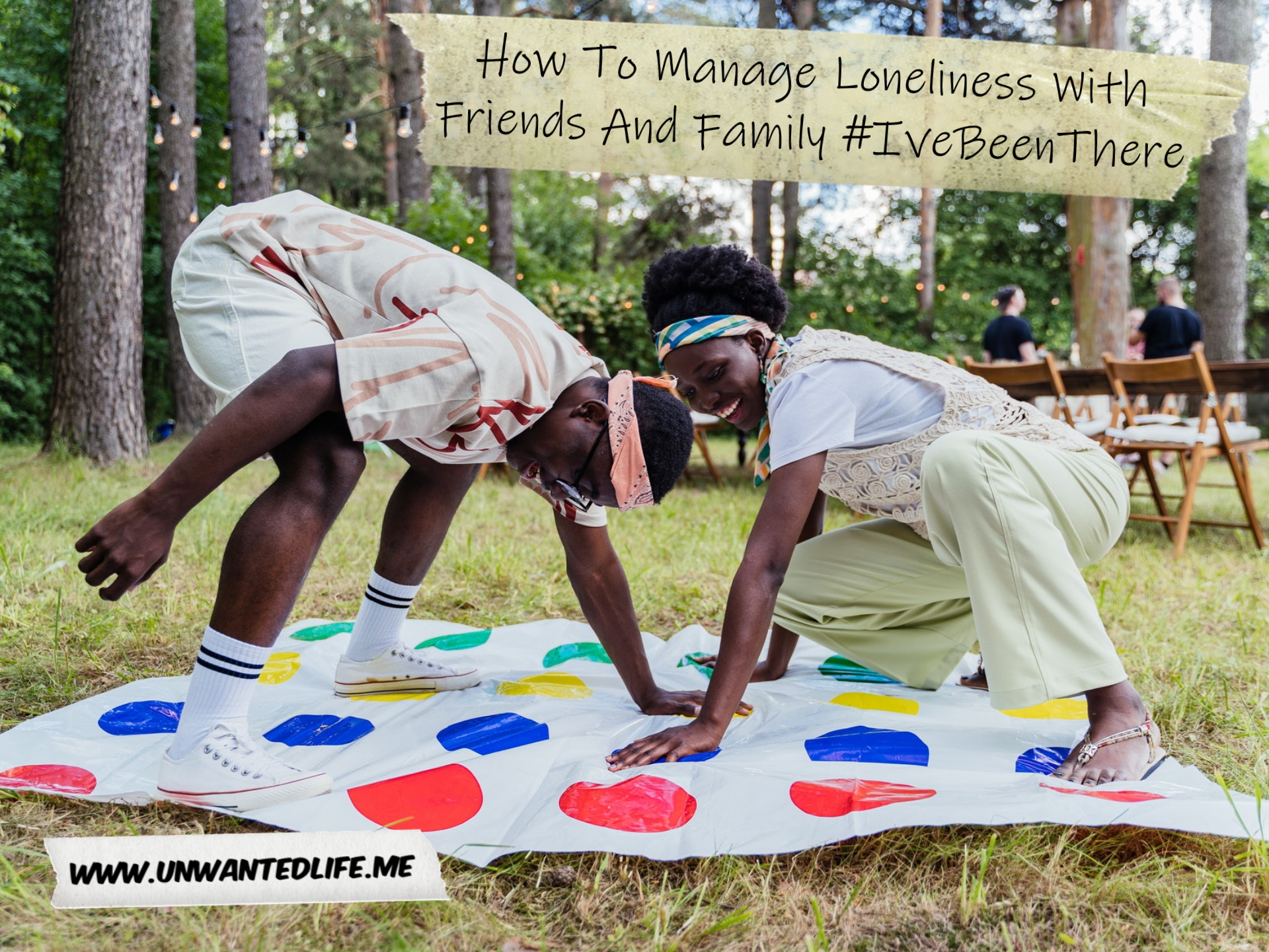 A Black man and woman playing twister outdoors in the park to represent the topic of the article - How To Manage Loneliness With Friends And Family #IveBeenThere