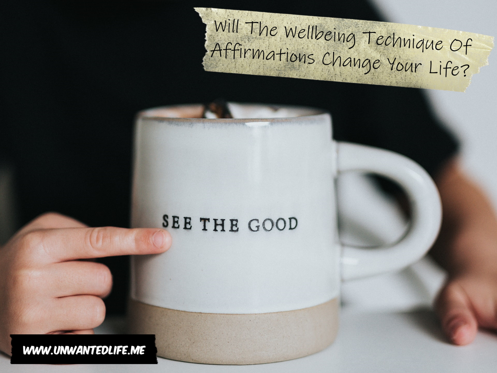 A photo of a child's hand pointing at some writing on a mug that says "see the good" to represent the topic of the article - Will The Wellbeing Technique Of Affirmations Change Your Life?