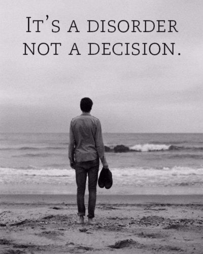 A black and white image of a man standing at the beach looking out at the seas with words above his head that say "It's a disorder, not a decision"