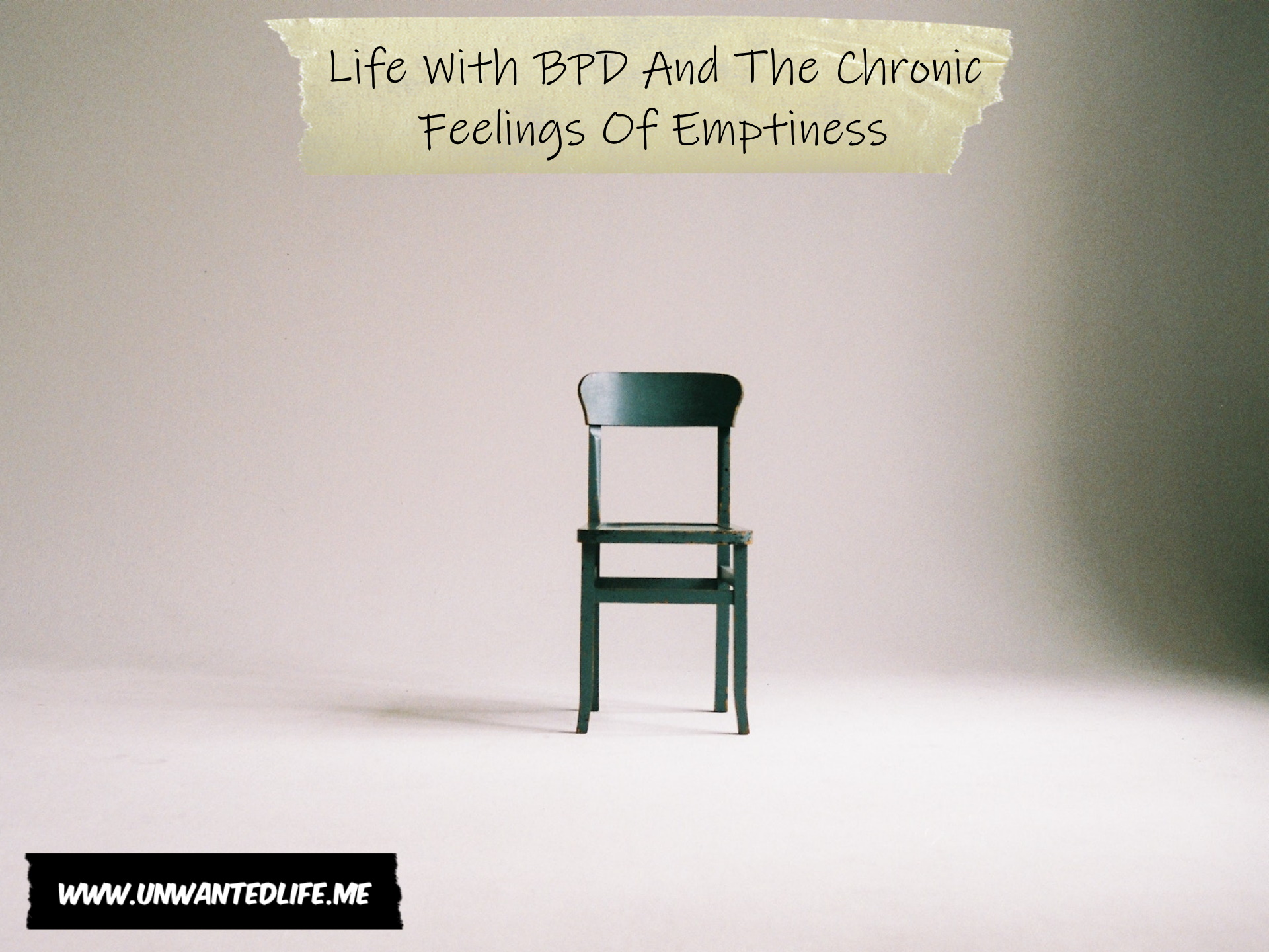 A photo of a simple green wooden dining chair in an all white empty room to represent the topic of the article - Life With BPD And The Chronic Feelings Of Emptiness
