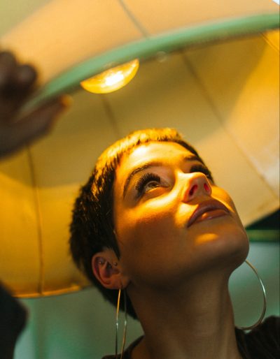 A woman angling a light over her head