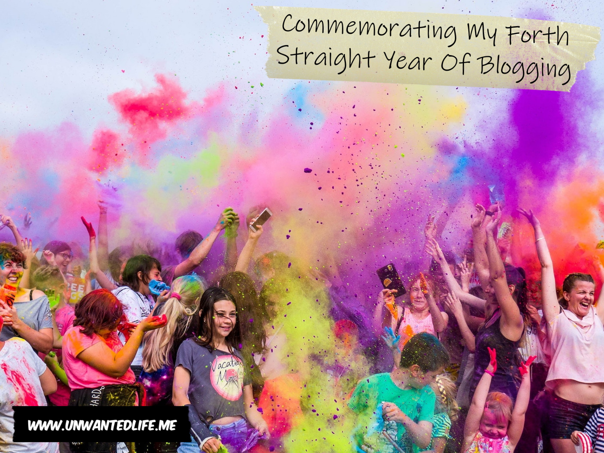 A group of people celebrating by throwing powdered paints around to represent the topic of the article - Commemorating My Forth Straight Year Of Blogging