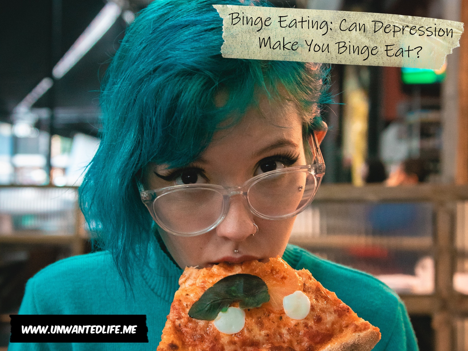A photo of a White woman with blue hair and clear framed glasses eating a slice of pizza to represent the topic of the article - Binge Eating: Can Depression Make You Binge Eat?