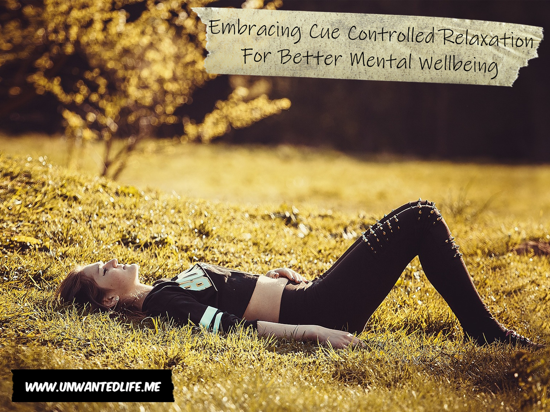A photo of a White goth laying in a field relaxing to represent the topic of the article - Embracing Cue Controlled Relaxation For Better Mental Wellbeing