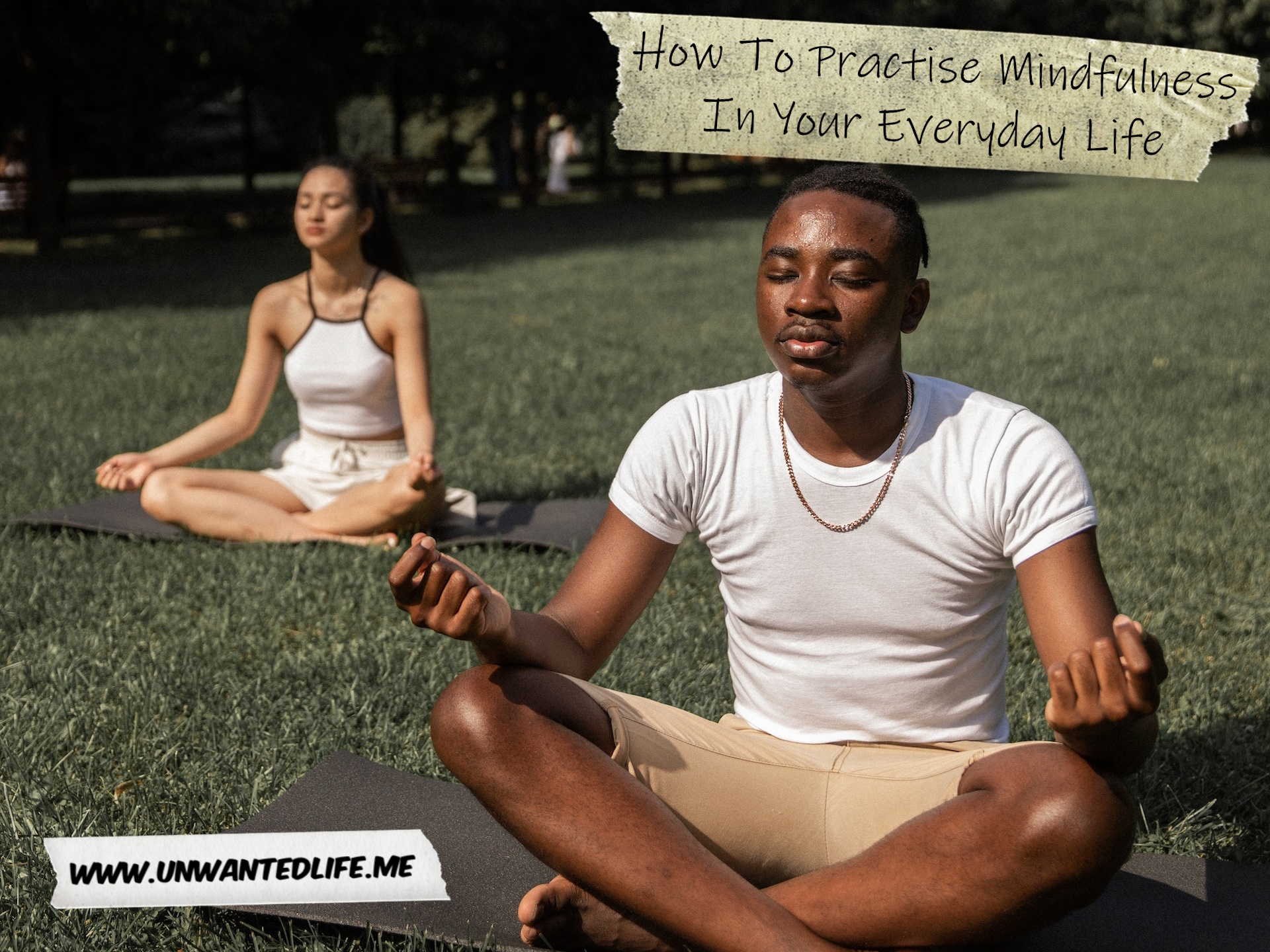 A photo of a Black man and an Asian woman meditating in the park to represent the topic of the article - How To Practise Mindfulness In Your Everyday Life