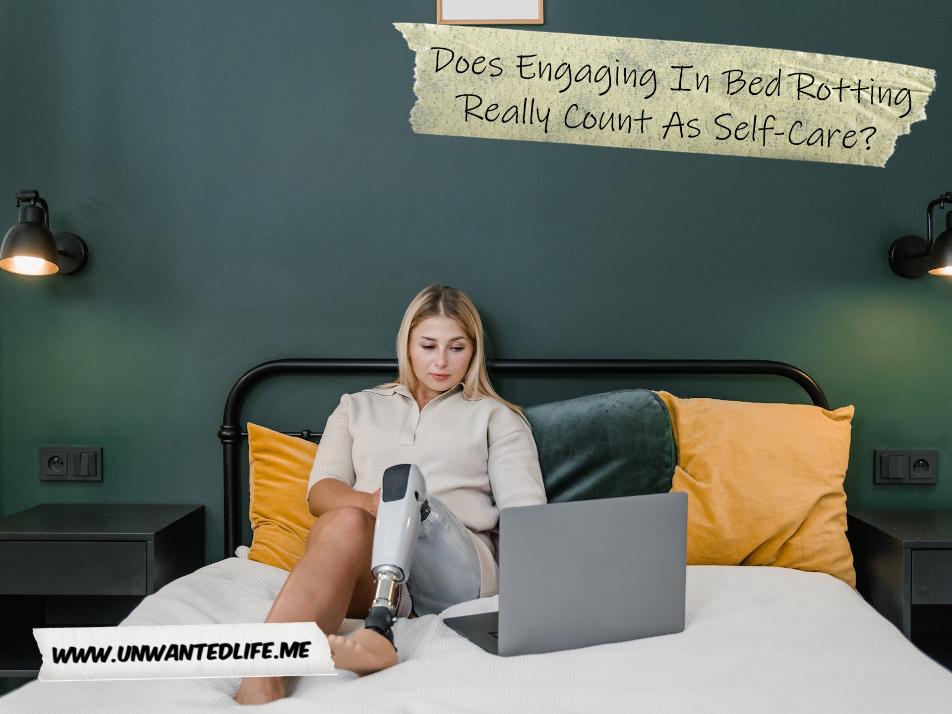 A White woman with a prosthetic leg looking at her laptop in bed to represent the topic of the article - Does Engaging In Bed Rotting Really Count As Self-Care?