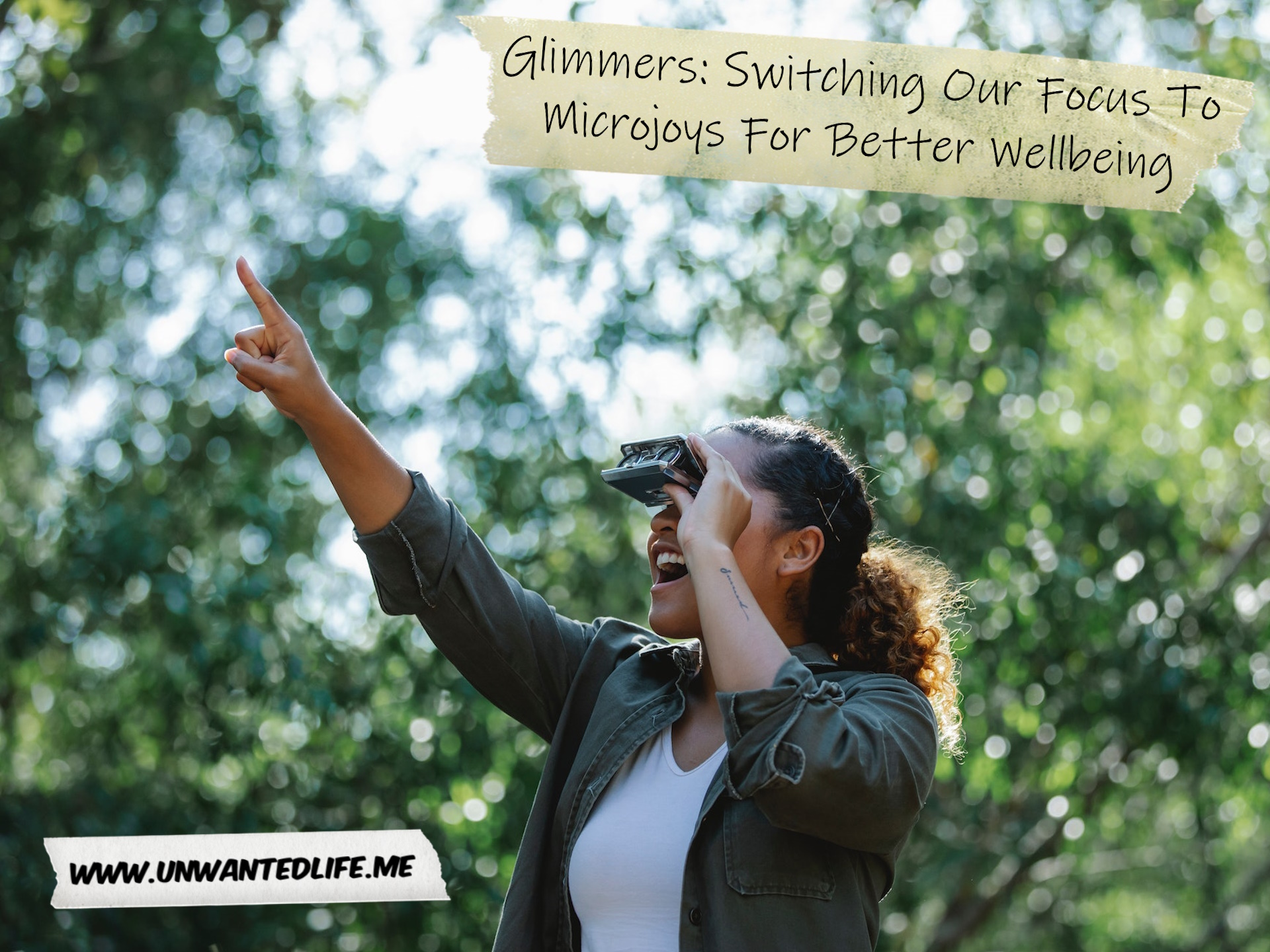 A Black woman looking through a small set of binoculars, smiling, and pointing to represent the topic of the article - Glimmers: Switching Our Focus To Microjoys For Better Wellbeing