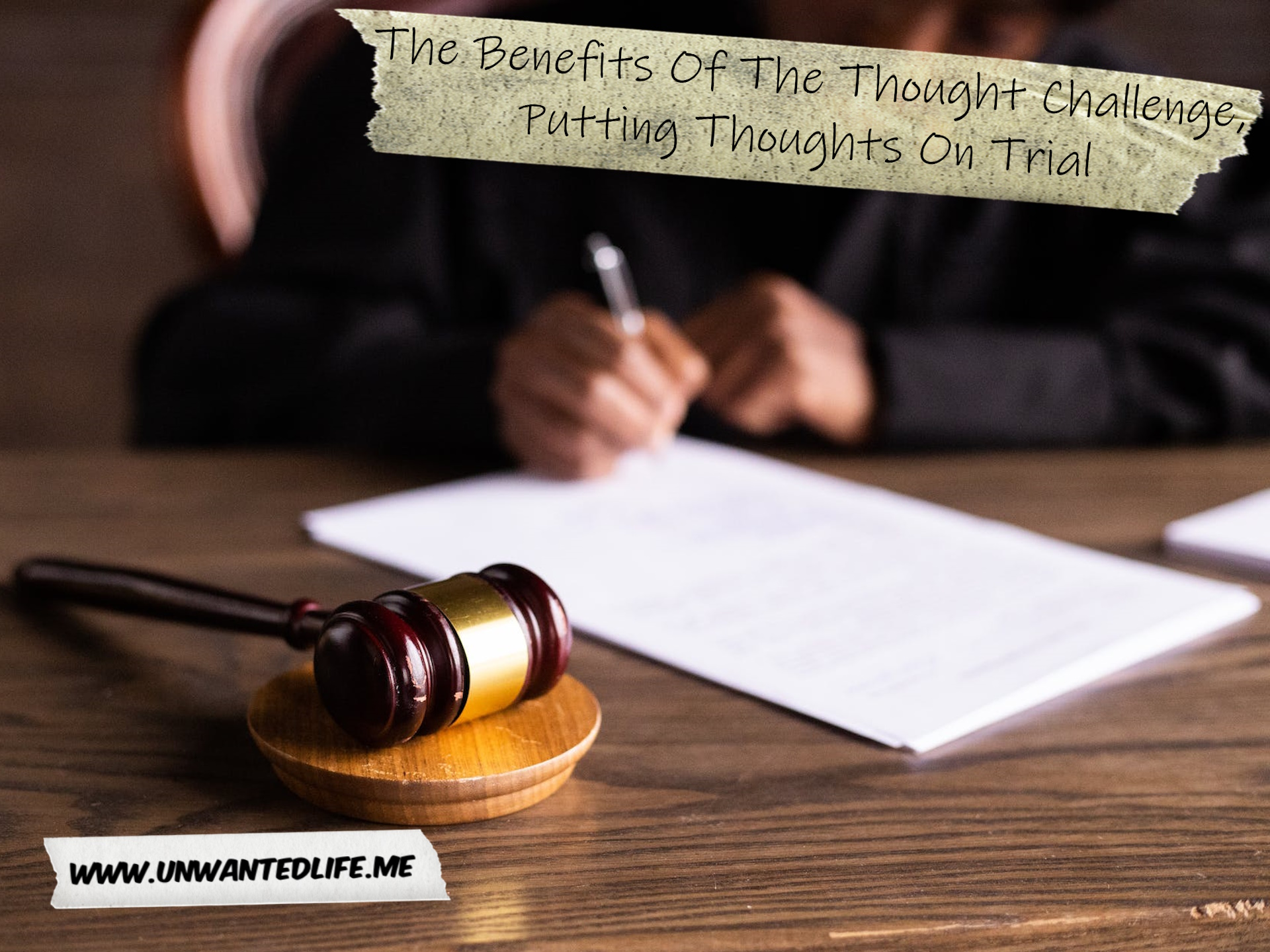 A photo of a Black judge filling in paperwork with their gavel in the foreground to represent the topic of the article - The Benefits Of The Thought Challenge, Putting Thoughts On Trial