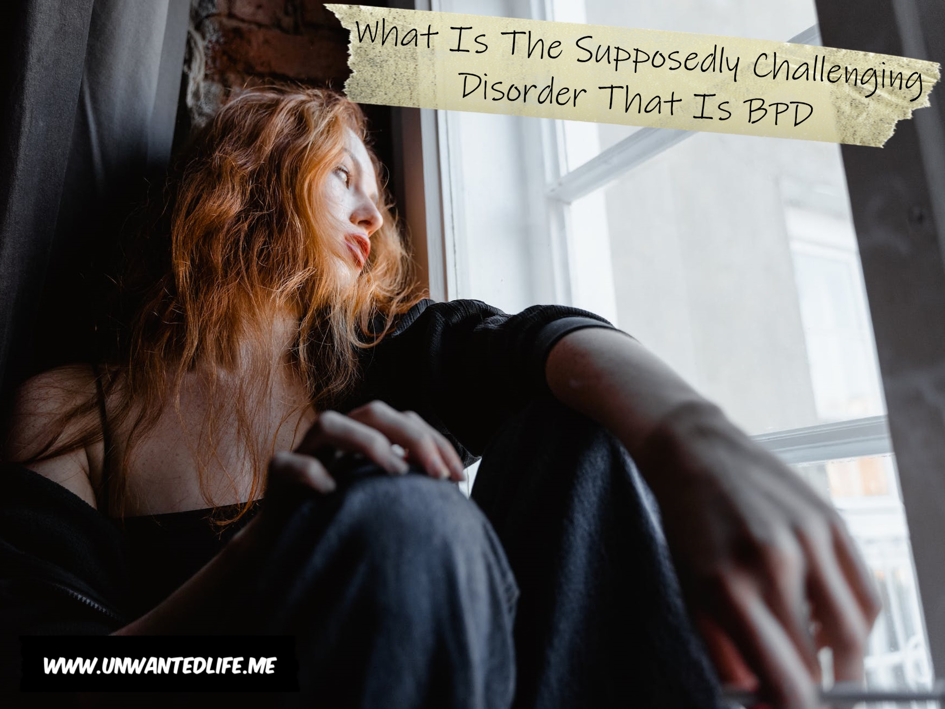 A red headed White woman looking out of a window looking sad to represent the topic of the article - What Is The Supposedly Challenging Disorder That Is BPD