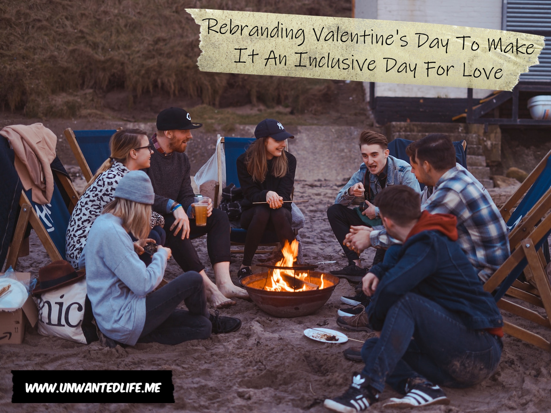 A photo of a group of friends sitting around a fire on a cold beach to represent the topic of the article - Rebranding Valentine's Day To Make It An Inclusive Day For Love