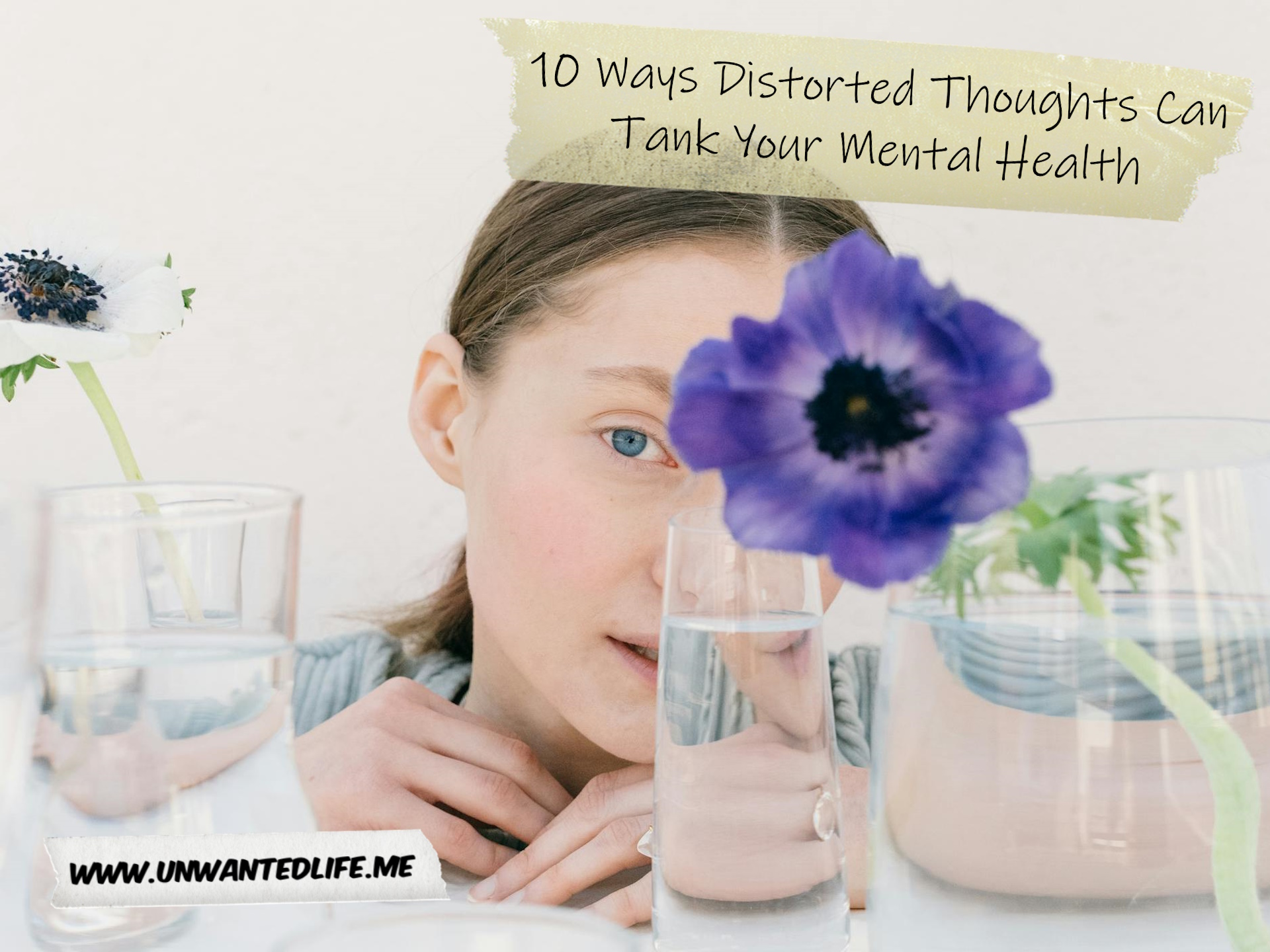 A photo of a White woman sitting behind several glasses partly filled with water that distorts how we're able to see her. This image was chosen to represent the topic of the article - 10 Ways Distorted Thoughts Can Tank Your Mental Health