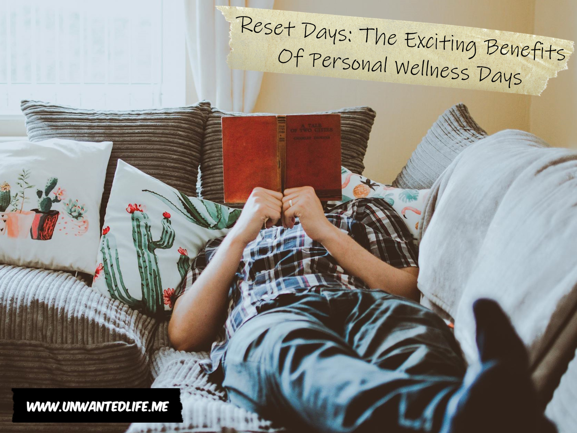A photo of a man reading a book while laying on a sofa to represent the topic of the article - Reset Days: The Exciting Benefits Of Personal Wellness Days