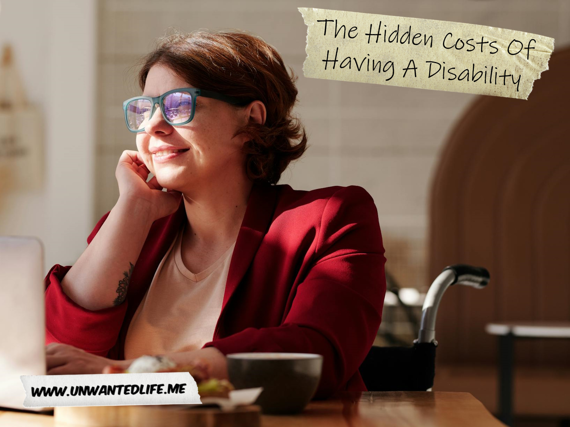 A photo of a White woman in a wheelchair, sitting at their desk thinking, to represent the topic of the article - The Hidden Costs Of Having A Disability