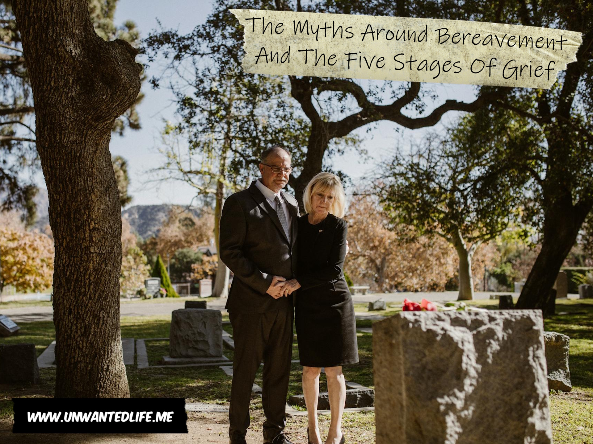 An older interracial couple in mourning in front of a grave to represent the topic of the article - The Myths Around Bereavement And The Five Stages Of Grief