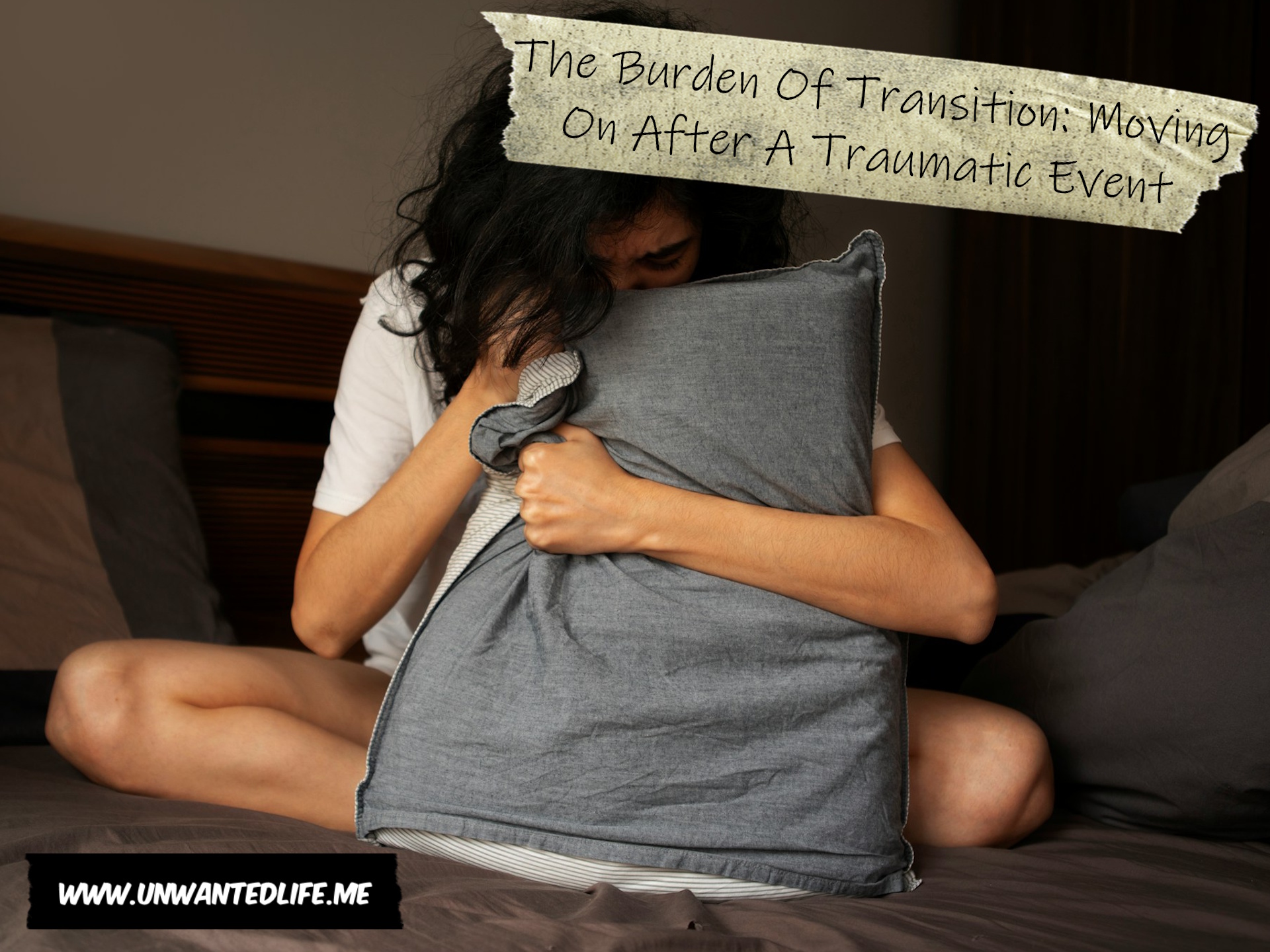 An image of a woman wrapped around a pillion in bed, upset. The Burden Of Transition: Moving On After A Traumatic Event