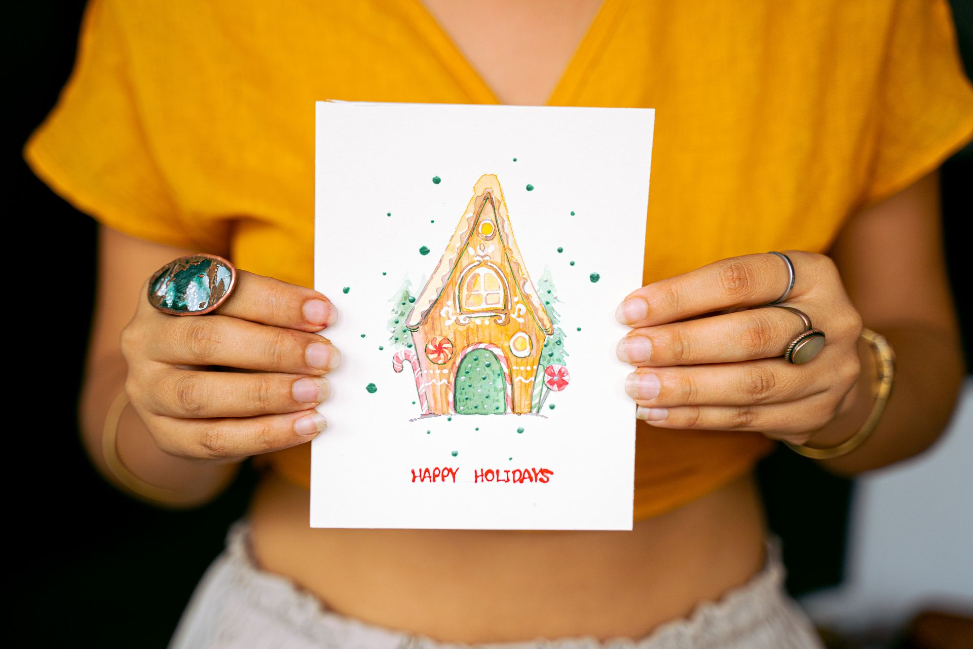 A woman holding a Happy Holidays card to represent the topic of the article - My Changing Views About Christmas And Other Celebrations