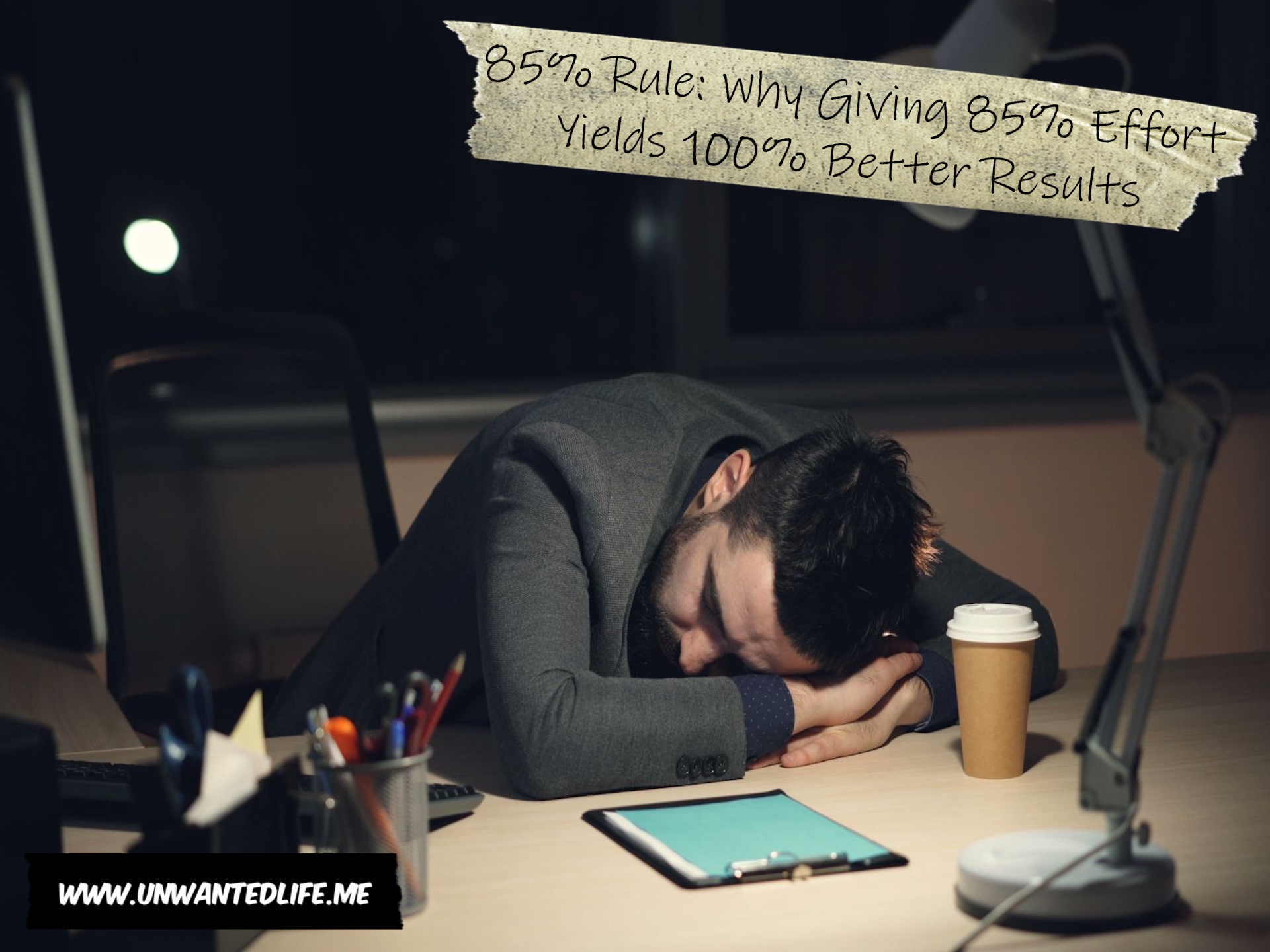 An image of a man sleeping at his desk to represent the topic of the article - 85% Rule: Why Giving 85% Effort Yields 100% Better Results