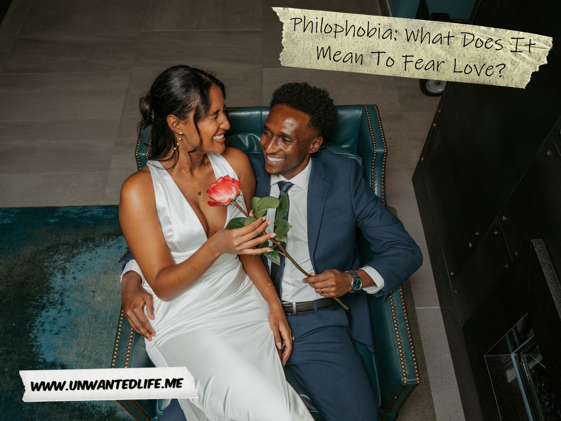 A photo of a couple sitting together on their wedding day to represent the topic of the article - Philophobia: What Does It Mean To Fear Love?