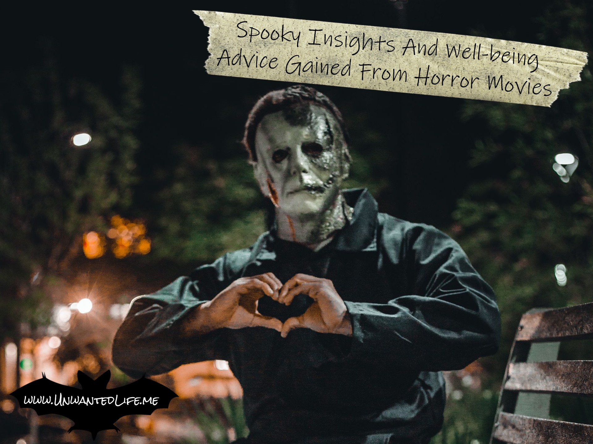 A photo of someone dressed as Michael Myers, sitting on a park bench, and making a heart shape with their hands to represent the topic of the article - Spooky Insights And Well-being Advice Gained From Horror Movies