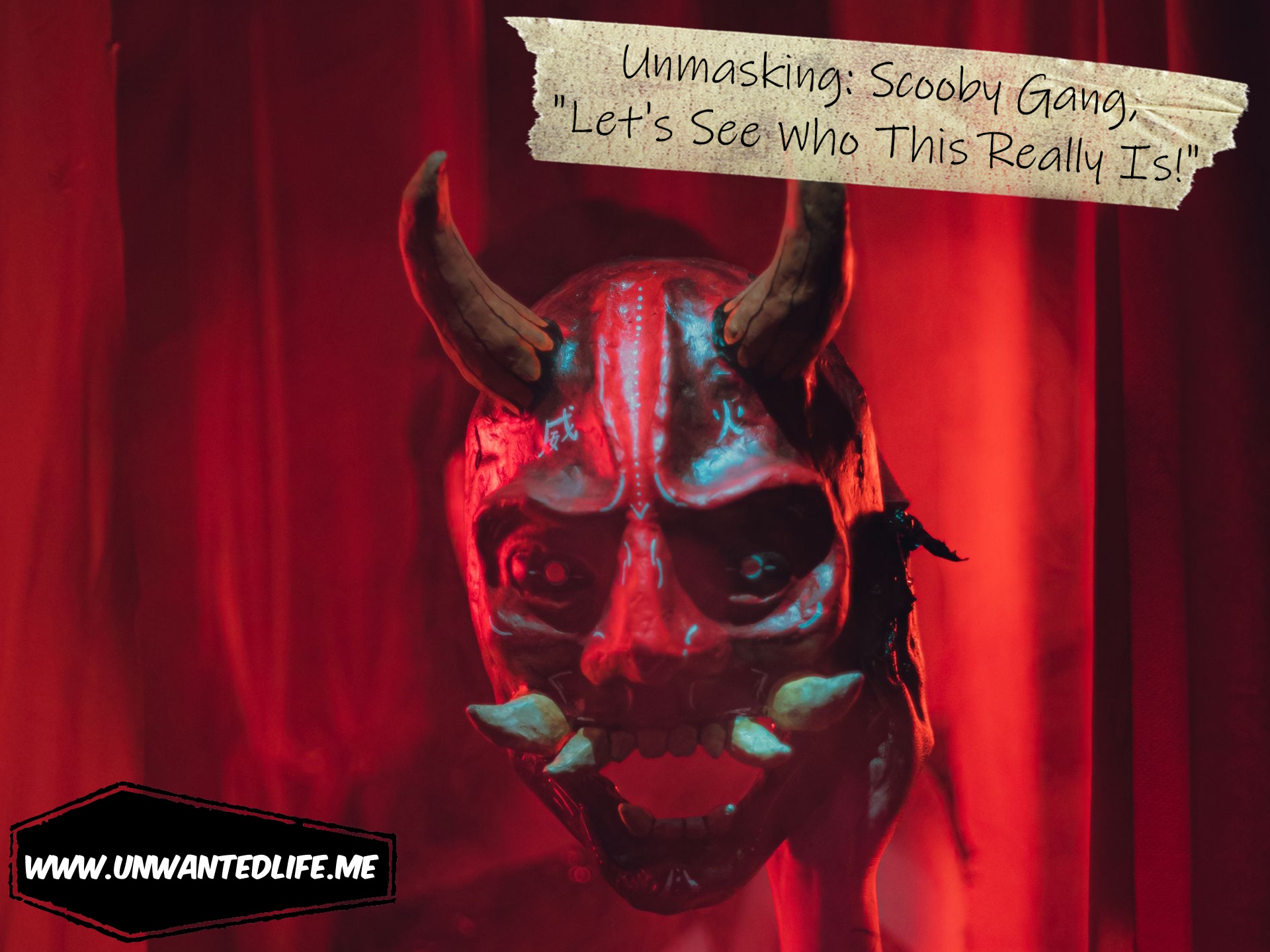 A photo of someone who's taken off their devil mask but it holding it at arm's length in a way that still covers their face, to represent the topic of the article - Unmasking: Scooby Gang, "Let's See Who This Really Is!"